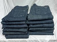 Stack of 13 folded Habitual jeans showing embroidered back pockets