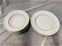 Stacked soup bowls and dinner plates showing Golden Swirl pattern