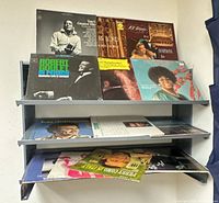 Overall view of three‐tier shelf displaying multiple LP covers