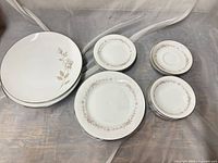 Stacked Sweettalk dinner plates and assorted Rosepoint pieces