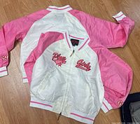 Both jackets front and back view on floor