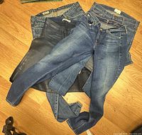 All four pairs of jeans spread out to show washes and waist labels
