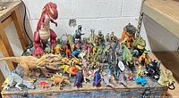 Full group of assorted dinosaur toys on table