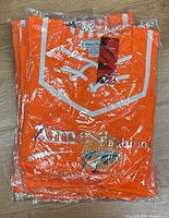 Stack of eight sealed bright orange Anne Fashion pajama sets