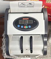 Front view of Semacon S-1000 money counter showing display and controls