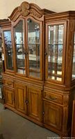 Front view of two-piece Thomasville Place Vendome lighted hutch