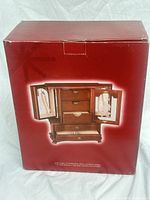 Front of product box showing walnut jewelry armoire image