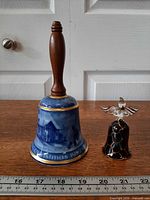 Both bells side by side with ruler for scale