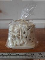 Front view sealed ceramic holder showing Snowbaby, bear, star cutouts