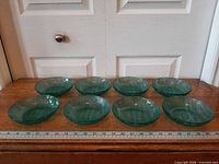 All eight teal Arcoroc glass bowls with ruler for scale