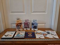 Entire lot on table showing all tapes, DVDs and pamphlets