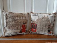 Both tapestry pillows side by side against door