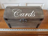 Front angled view showing card slot, script text, latch, and ruler for scale