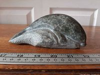 Left side profile of soapstone seal beside ruler