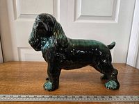 Full left-side view of Blue Mountain Pottery Cocker Spaniel figurine with ruler for scale