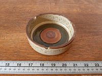 Top view of ashtray showing interior glaze and diameter on ruler