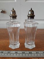 Front view of pair showing hexagonal crystal bodies and metal lids