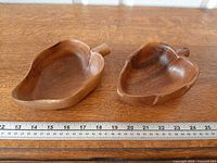 Top view of both Monkey Pod dishes with ruler for scale