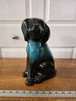 Front angle of ceramic dog figurine with ruler for scale