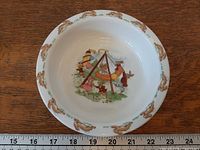 Top view showing interior Swinging Boats scene and running rabbit border with ruler for scale