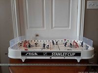 Front view of full tabletop hockey game on base, showing branding and overall condition