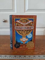 Front view of the hardcover book standing upright showing illustrated cover and Caldecott Medal seal