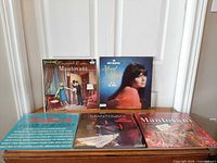 Five record sleeves including outer slipcase displayed on a table