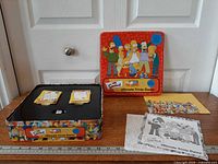 overall lot showing tin with lid, contents laid out