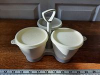 Front angle showing three containers with lids and handle