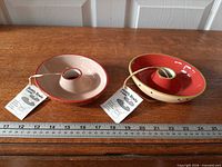 Two ceramic Ganz bottle bowls with tags and ruler for scale
