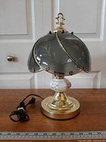 Full view of lamp with cord and ruler for scale