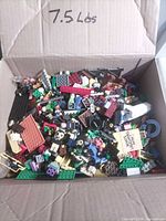 Full box view showing mixed LEGO pieces and 7.5 lbs note