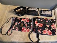 Full lot showing two floral crossbody bags, coin pouch, two folded "Bag in a bag" pouches