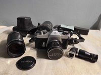 Camera body, telephoto lens, caps, leather case, strap, right-angle finder
