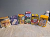 Front view of all six tins