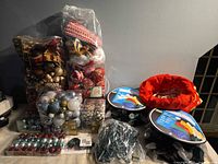 Bulk lot showing ornament packages, LED light reels, red tree collar, mini lights
