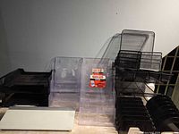 Full lot overview showing mesh organizer, clear acrylic trays, black plastic trays and glass pad
