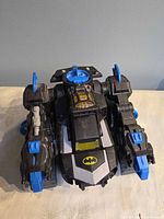 Top view of Bat Bot in tank mode showing Batman logo and blue accents