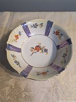 Top view showing floral pattern, lavender panels and gilded rim