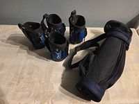four blue neoprene koozies and blue nylon sling bag overview