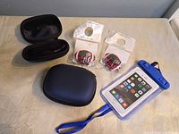 Entire lot overview showing two cases (one open), two packaged football magnets, waterproof phone pouch with lanyard