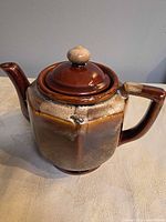 Front left view showing body, spout, handle, glaze, crazing