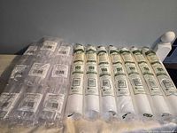 Overview of all sealed rolls of cups and packs of shot glasses