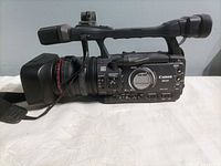 Right side view of Canon XH A1 camcorder showing control panel and lens hood