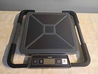 Top view showing entire Dymo scale with folded support arms and control panel