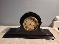 Front view showing tambour case, dial, missing glass