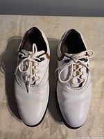 Top view showing white and brown leather uppers and laces