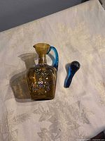 Decanter, stopper separated, showing front floral decoration