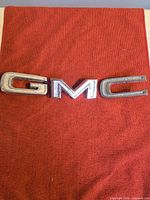 Front view of GMC emblem on red background