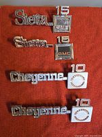 All four GMC emblems laid out on red fabric